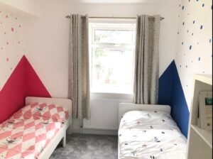 Children’s Bedroom with Pink and Blue Geometric Walls
