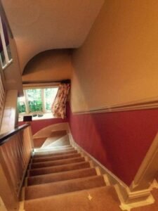 Stairwell Redecoration with White Balusters and Dark Handrails
