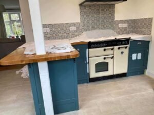Kitchen Cabinet Repainting with Blue and Muted Green Finishes