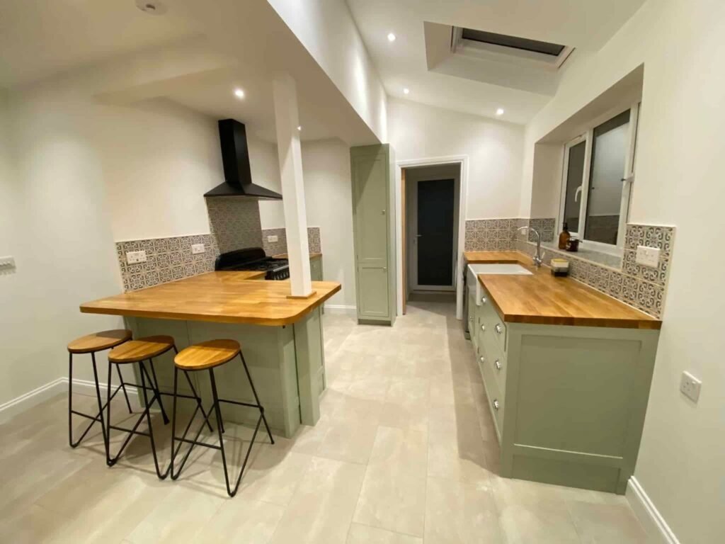 Kitchen Cabinet Repainting with Blue and Muted Green Finishes