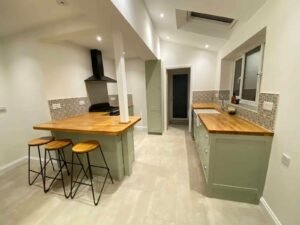 Kitchen Cabinet Repainting with Blue and Muted Green Finishes