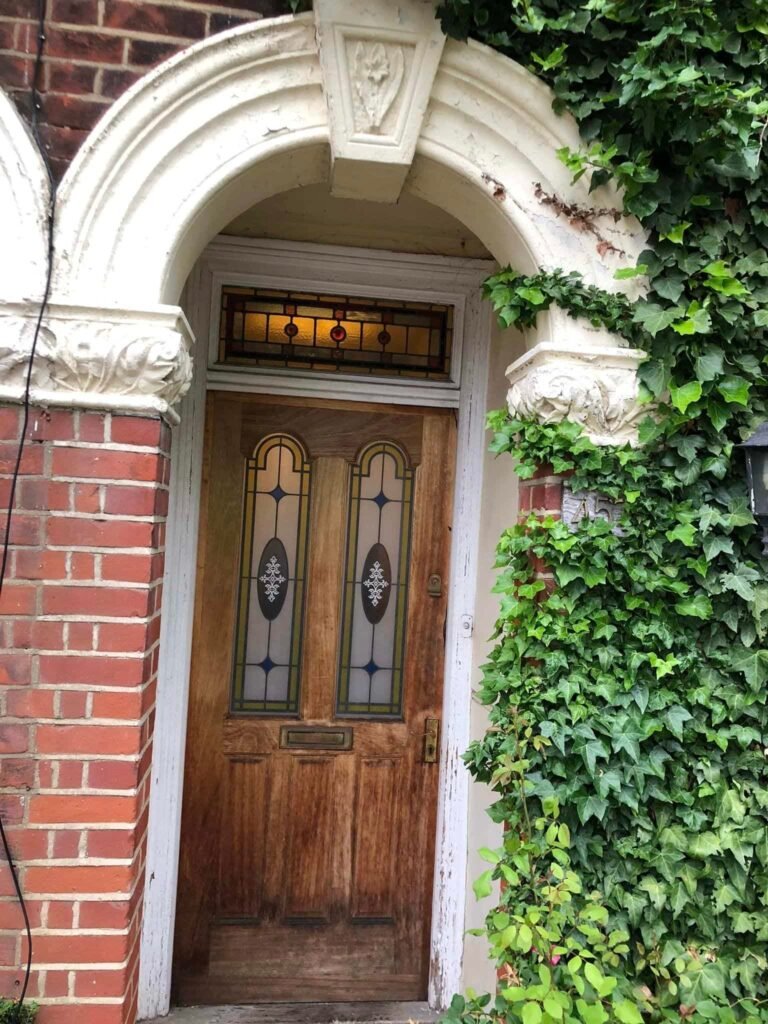 Red Front Door with an Arched Period Surround — before
