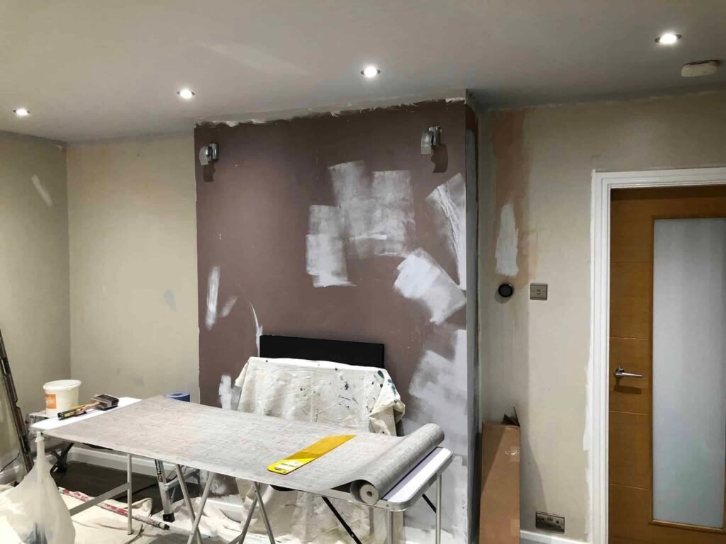 Living Room Wallpapering with a Textured Grey Finish — before