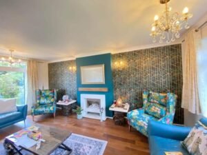 Teal Living Room with Geometric Feature Wallpaper